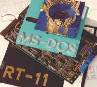 
 Symbolic still life of 
 an RT-11 floppy disk,
 the BAYDEL BRX50 board, 
 MS-DOS diskettes and
 a tiny crown 
 (12 Kbytes JPEG)

